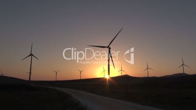 sunset or sunrise in turbines field