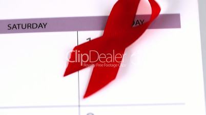 Red ribbon falling on a calendar