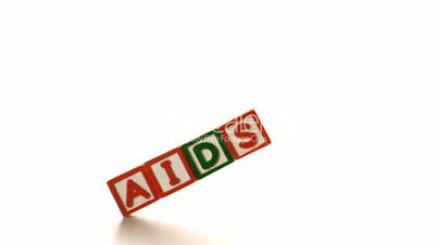 Aids spelled out in blocks falling over