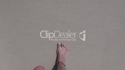 woman feet walking on beach