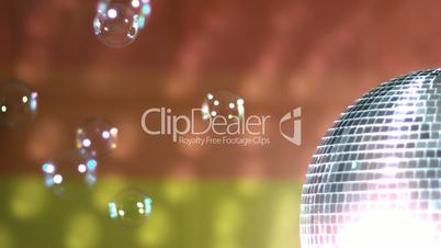 Shiny disco ball spinning with floating bubbles against rainbow flag