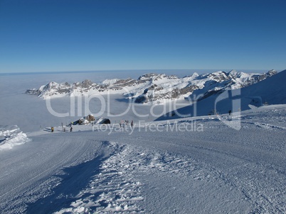 Ski region Titlis, snow covered mountains and sea of fog