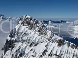 Harsh mountain peak next to the Titlis, sea of fog