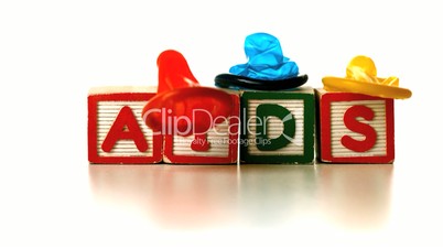 Colourful condoms falling on blocks spelling AIDS