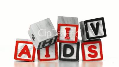 Blocks spelling HIV falling on blocks spelling AIDS