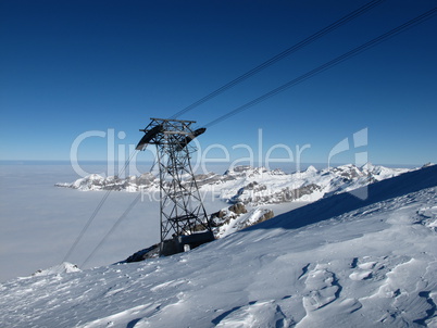 Cable car pylon, mountains and sea of fog, Titlis