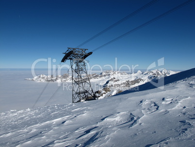 Cable car pylon on the Titlis, sea of fog and mountains