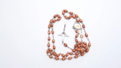 Rosary beads on white surface