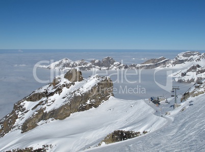 Winter day on the Titlis, Chair lift and sea of fog