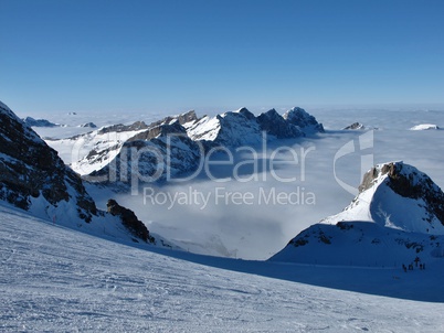 Ski slope and sea of fog, mountains