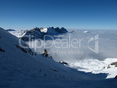 From the sun into the fog, ski slopes on the Titlis