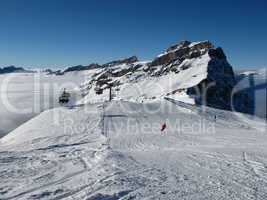 Ski slopes, mountain and sea of fog, Titlis ski area