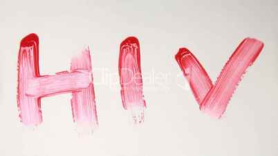 Hand painting the word HIV in red paint