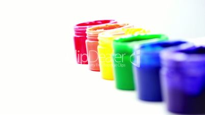 Rainbow paint pots in a line for gay pride