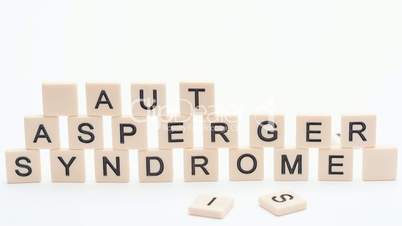 Autism and asperger spelled out in plastic letter pieces