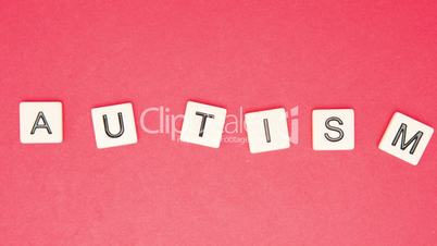 Autism spelled out in letter pieces among many