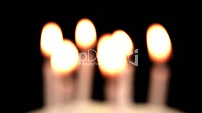 Focus on birthday candles being blown out