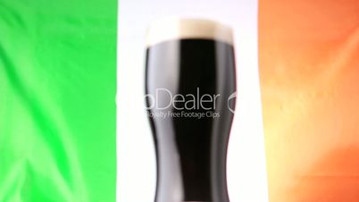 Pint of stout against irish flag