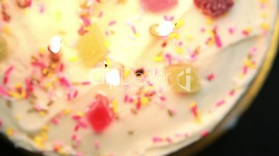 Revolving birthday cake with candles blown out