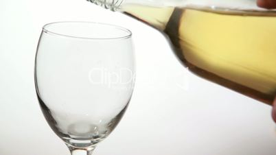 Glass being filled with white wine