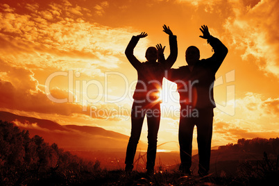 silhouettes young woman and man on a sunset