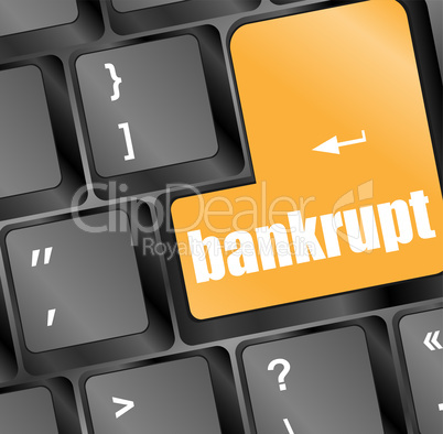A keyboard with a yellow key reading bankrupt