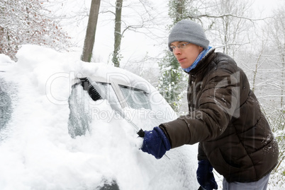 Mann befreit sein Auto vom Schnee