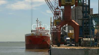 Cargo ship moving load in harbor Time lapse