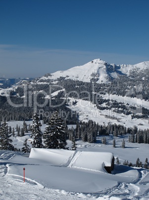 Ski track leading over a roof, mountains