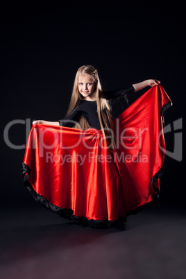 Pretty girl performing hispanic dance in dark