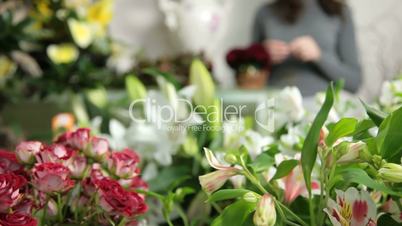 DOLLY: Florist Arranging Bouquet In Flower Shop