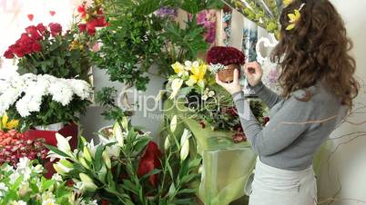 Florist Arranging Rose Heart Bouquet In Flower Shop