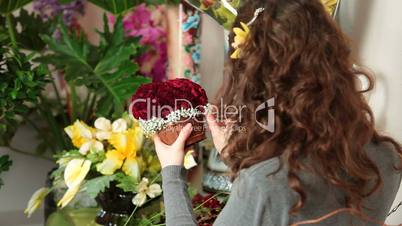 Florist Arranging Rose Heart Bouquet In Flower Shop