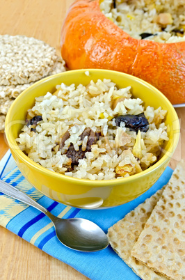 Rice porridge with pumpkin on the board