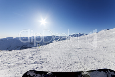 Snowboarder resting on ski slope
