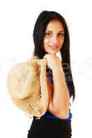 Girl holding straw hat.