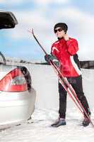 Woman with car and cross-country skis