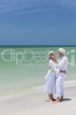 Happy Senior Couple Embracing on Tropical Beach