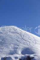 Off-piste slope with trace of skis on snow