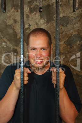 Young man behind the bars