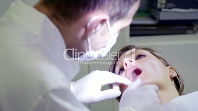 Dentist visiting, inspecting mouth and dental hygiene of female patient