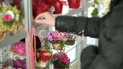 Customer Chooses Flower Gift in Florist Shop