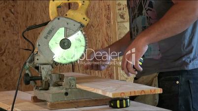 worker sawing a wooden board