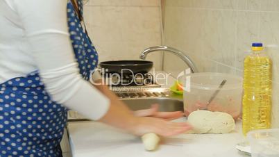 Woman Hands Kneading Stiff Dough In The Kitchen