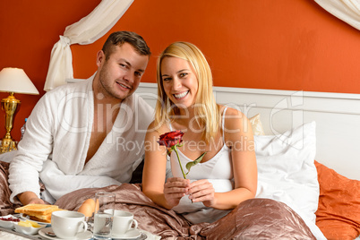 Smiling couple bed breakfast celebrating Valentine's