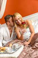 Romantic couple cuddling bed motel celebrating anniversary