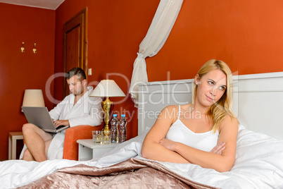 Upset girl sitting bed after fight boyfriend