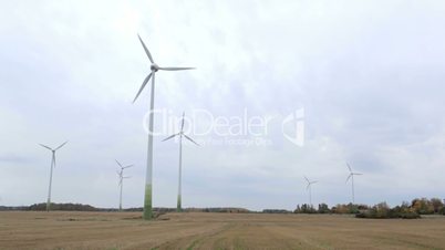 Many wind turbines in the field.