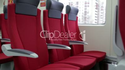 Red chairs in train.
