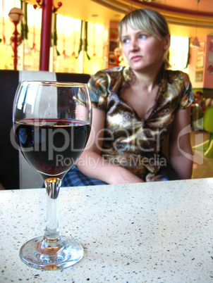 the girl with glass of red wine in restaurant